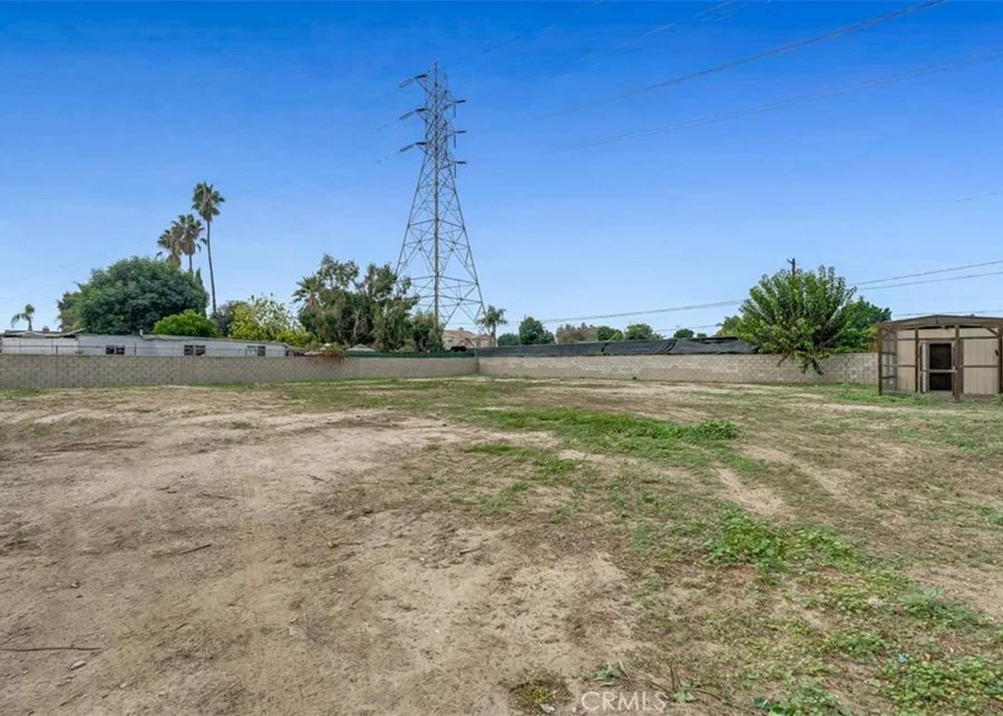 Power towers over a dirt yard