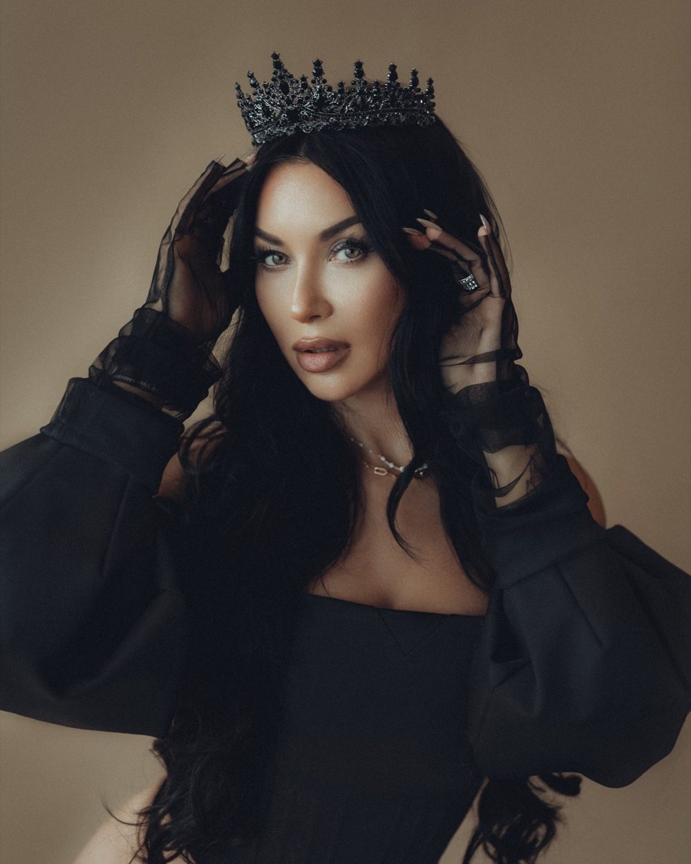 Polina Logunova wearing a black crown